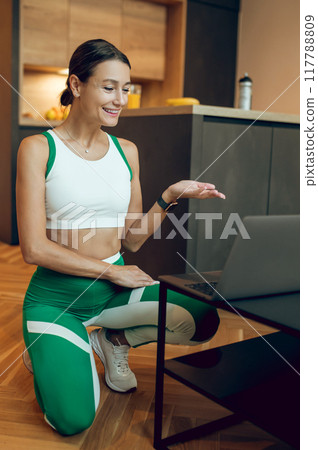 Woman fitness instructor teaching online class working making video blog about sport workout Woman fitness instructor teaching online class working making video blog about sport workout 117788809