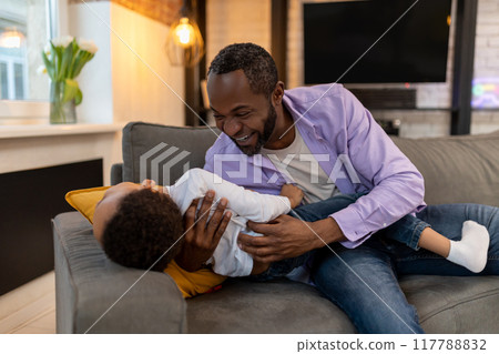 Dad hugging his son and looking happy and enjoyed Dad hugging his son and looking happy and enjoyed 117788832