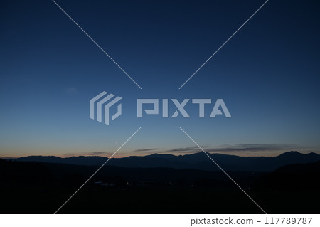 A very thin moon on the eve of the new moon over the Okuchichibu mountain range, seen from Hakushu Town, Hokuto City 117789787