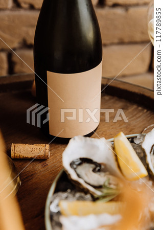 Elegant wine bottle with oysters and lemon, perfect for luxury dining and fine dining concepts Elegant wine bottle with oysters and lemon, perfect for luxury dining and fine dining concepts 117789855