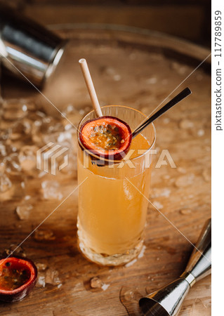 Refreshing passion fruit cocktail in highball glass, for summer vibes and tropical-themed events 117789859