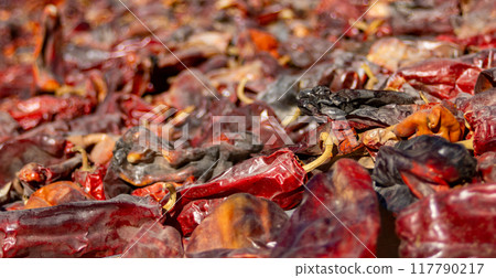 Close-up horizontal shot of peppers drying in the sun in a smokehouse Close-up horizontal shot of peppers drying in the sun in a smokehouse 117790217