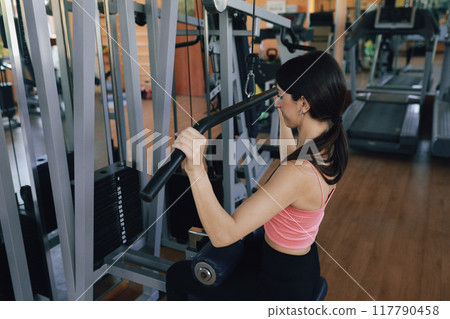 Woman Pulling Down The Bar Of The Lat Machine  117790458