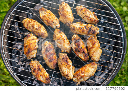 chicken wings grilling on charcoal grill chicken wings grilling on charcoal grill 117790602