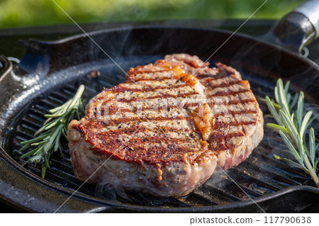 beef steak on grilling pan 117790638