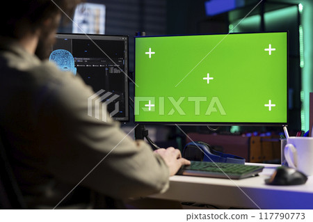Developer updating artificial intelligence machine learning algorithm on isolated screen PC desktop. IT specialist in apartment office uses programming to upgrade AI on chroma key monitor 117790773