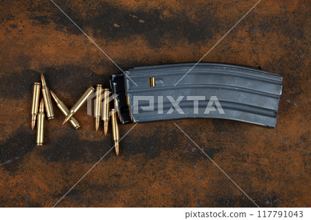Ammunition with magazine on rusty metal 117791043