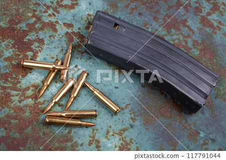 Ammunition with magazine on rusty metal Ammunition with magazine on rusty metal 117791044