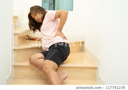 Asian lady fall down the stairs and pain at hip and waist because slippery surfaces. 117791239