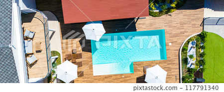 Panorama with top view of beautiful villa with swimming pool and wooden terrace 117791340