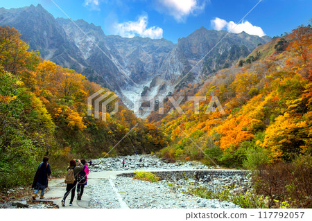 Tourists looking up at Ichinokura with autumn leaves 117792057