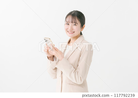 A woman in a suit that uses a smartphone 117792239