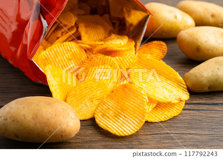 Potato chips, delicious BBQ seasoning spicy for crips, thin slice deep fried snack fast food in open bag. Potato chips, delicious BBQ seasoning spicy for crips, thin slice deep fried snack fast food in open bag. 117792243