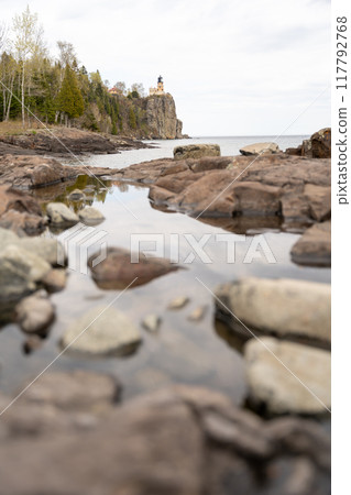 A beautiful view of Split Rock Lighthouse on the rocky coast of Lake Superior. 117792768