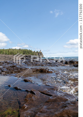 A beautiful view of Split Rock Lighthouse on the rocky coast of Lake Superior. 117792800