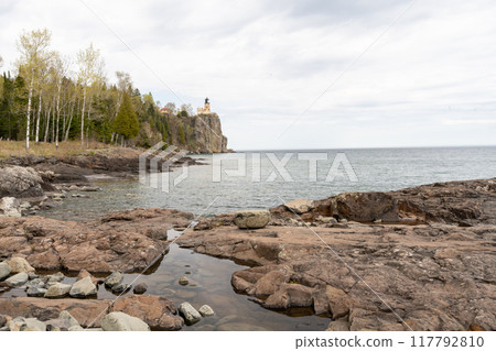 A beautiful view of Split Rock Lighthouse on the rocky coast of Lake Superior. 117792810