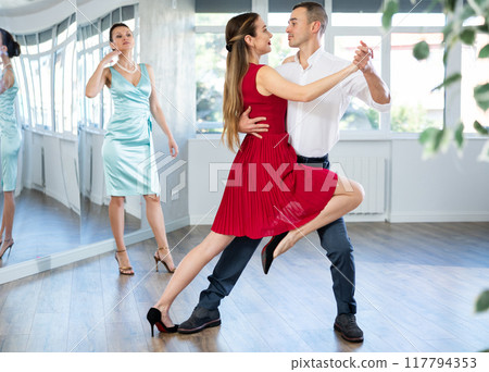 Graceful duet dancing passionate tango during dance class 117794353