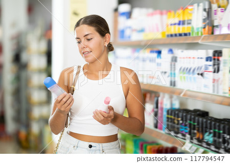 Girl customer in store chooses interested in deodorant, Girl customer in store chooses interested in deodorant, 117794547