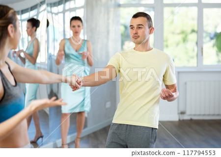 Man enjoying vigorous jive with female partner at dance class Man enjoying vigorous jive with female partner at dance class 117794553