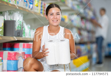 Young woman choosing paper towels in store Young woman choosing paper towels in store 117794571
