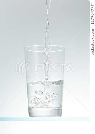 Pour water into the glass 117794777