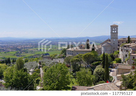 St. Francis Church and green fields seen from the heights of Assisi St. Francis Church and green fields seen from the heights of Assisi 117795127