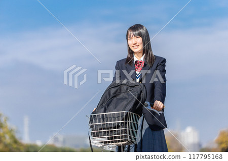 School girls riding a bicycle School girls riding a bicycle 117795168
