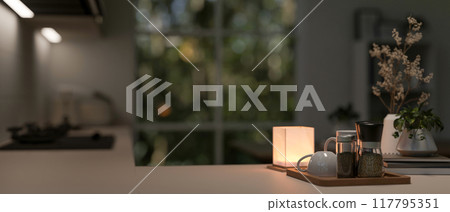 A close-up image of a kitchen countertop with a cozy atmosphere, illuminated by a table lamp. A close-up image of a kitchen countertop with a cozy atmosphere, illuminated by a table lamp. 117795351