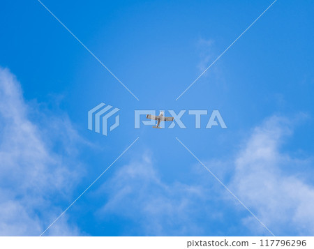Small ultralight airplane with overhead wing and single propeller flying in sunset sky. Small ultralight airplane with overhead wing and single propeller flying in sunset sky. 117796296