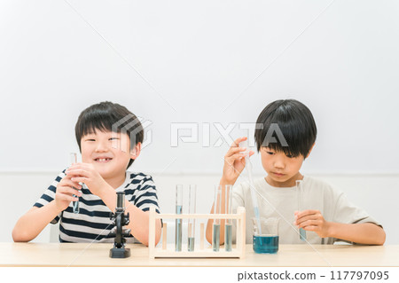 Elementary school boy doing science experiments Elementary school boy doing science experiments 117797095