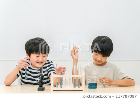 Elementary school boy doing science experiments Elementary school boy doing science experiments 117797097