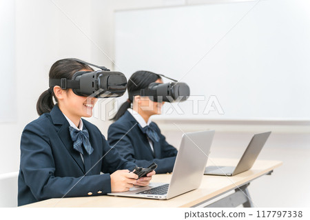 Junior high school and high school girls wearing VR goggles and playing PC games and studying (VR AR MR) 117797338