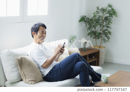 Men looking at smartphones Men looking at smartphones 117797387