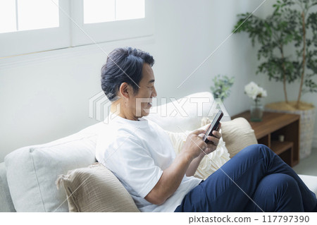 Men looking at smartphones Men looking at smartphones 117797390