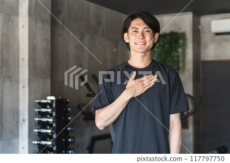 Young Asian man personal trainer instructor working at a sports gym Young Asian man personal trainer instructor working at a sports gym 117797750