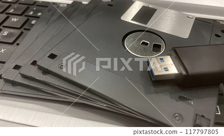 From Past to Present. The Evolution of Data Storage. The striking visual comparison between an old black floppy disk and today's blue USB stick symbolizes the rapid advancement of data storage technol From Past to Present. The Evolution of Data Storage. The striking visual comparison between an old black floppy disk and today's blue USB stick symbolizes the rapid advancement of data storage technol 117797805