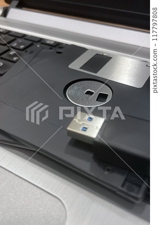 From Past to Present. The Evolution of Data Storage. The striking visual comparison between an old black floppy disk and today's blue USB stick symbolizes the rapid advancement of data storage technol From Past to Present. The Evolution of Data Storage. The striking visual comparison between an old black floppy disk and today's blue USB stick symbolizes the rapid advancement of data storage technol 117797808