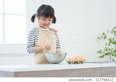 Child cooking in the kitchen Child cooking in the kitchen 117798522