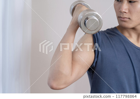 Young man doing muscle training, dumbbells, body parts 117798864