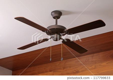 Wooden ceiling fan. Modern room cooling device with speed control. Summer and heat in room. 117799633