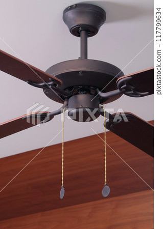 Wooden ceiling fan. Modern room cooling device with speed control. Summer and heat in room. 117799634
