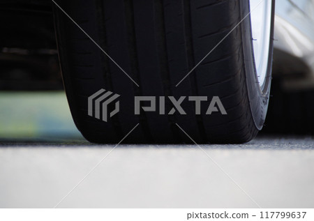 A low-angle photo of the contact area of a high-grip tire 117799637