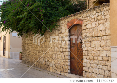 Stone wall and wooden door Stone wall and wooden door 117800752