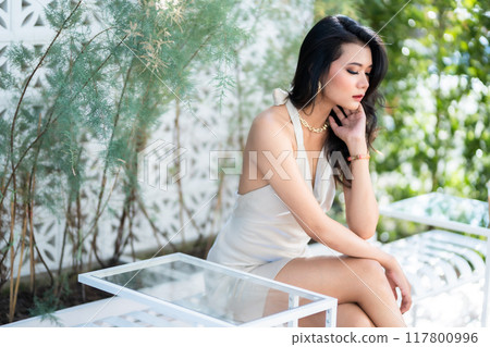 Portrait beautiful asian freelance Success people business woman fashion model in summer white sleeveless dress and coffee in cup in coffee shop. Portrait beautiful asian freelance Success people business woman fashion model in summer white sleeveless dress and coffee in cup in coffee shop. 117800996
