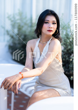 Portrait beautiful asian freelance Success people business woman fashion model in summer white sleeveless dress and coffee in cup in coffee shop. Portrait beautiful asian freelance Success people business woman fashion model in summer white sleeveless dress and coffee in cup in coffee shop. 117800999