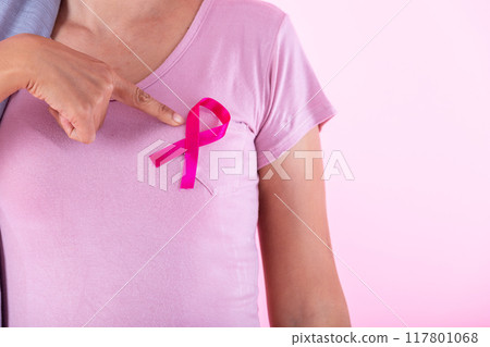 a asian women disease mammary cancer patient in pullover holding pink ribbon isolated on pink blank copy space studio background,healthcare,medicine concept 117801068