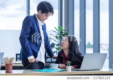 Stressed Business partners tomboy lesbian and business female working and  business plan on the laptop computer In the office room background. 117801125