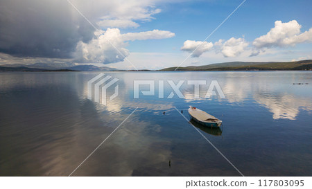 A small boat at beach of Urla, izmir. beautiful clouds 117803095