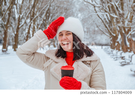 happy woman with coffee cup outdoors at winter cold day happy woman with coffee cup outdoors at winter cold day 117804009