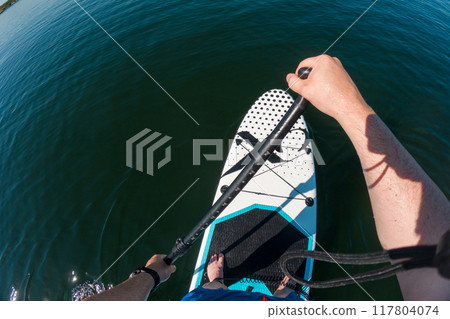 Paddleboarding on Calm Waters Paddleboarding on Calm Waters 117804074
